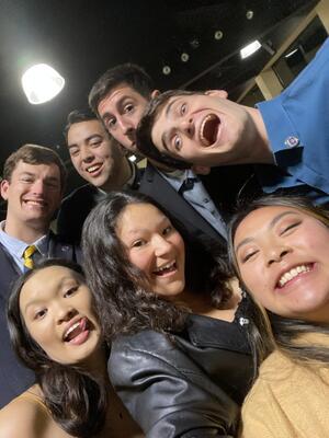 group of seven students standing together and smiling 