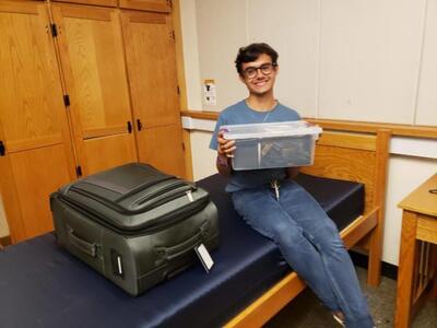 Ethan smiling with suitcase