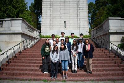group of people standing in front of the campanile 
